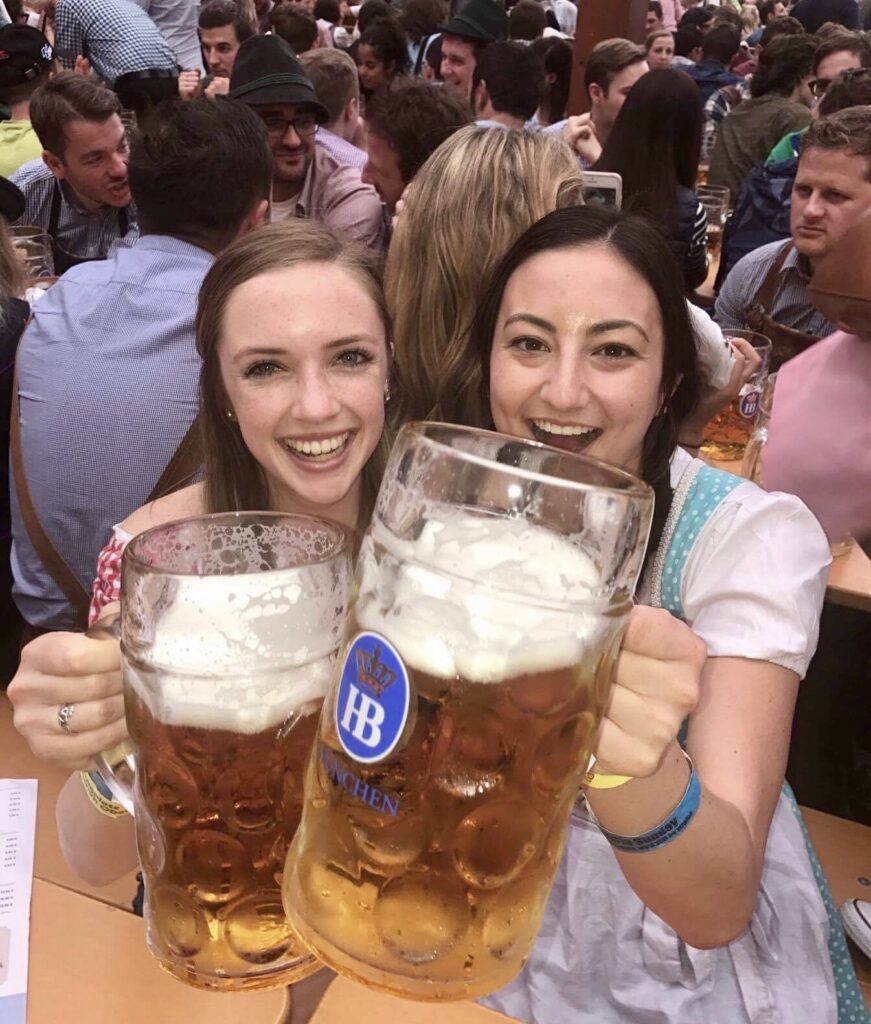 Two girls drinking beer at Octoberfest in Munich, Germany