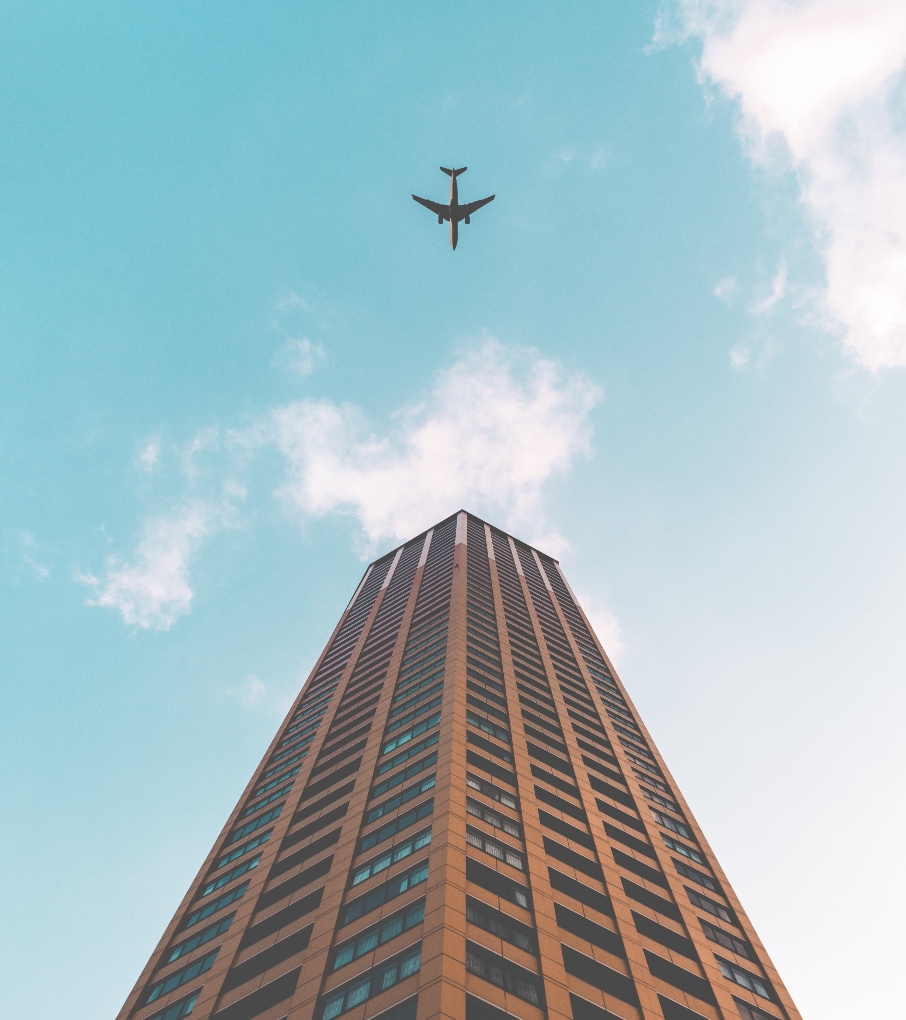 airplane over a skyscraper
