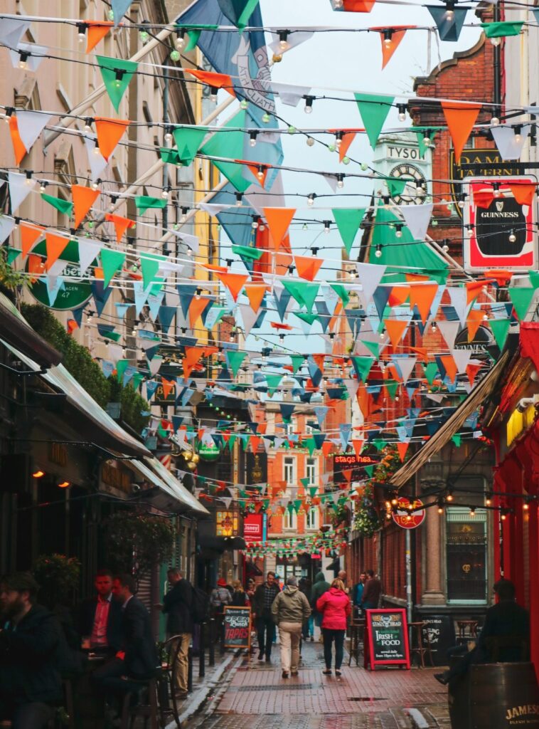 A festive street in Dublin with Irish flags streamed overhead.
