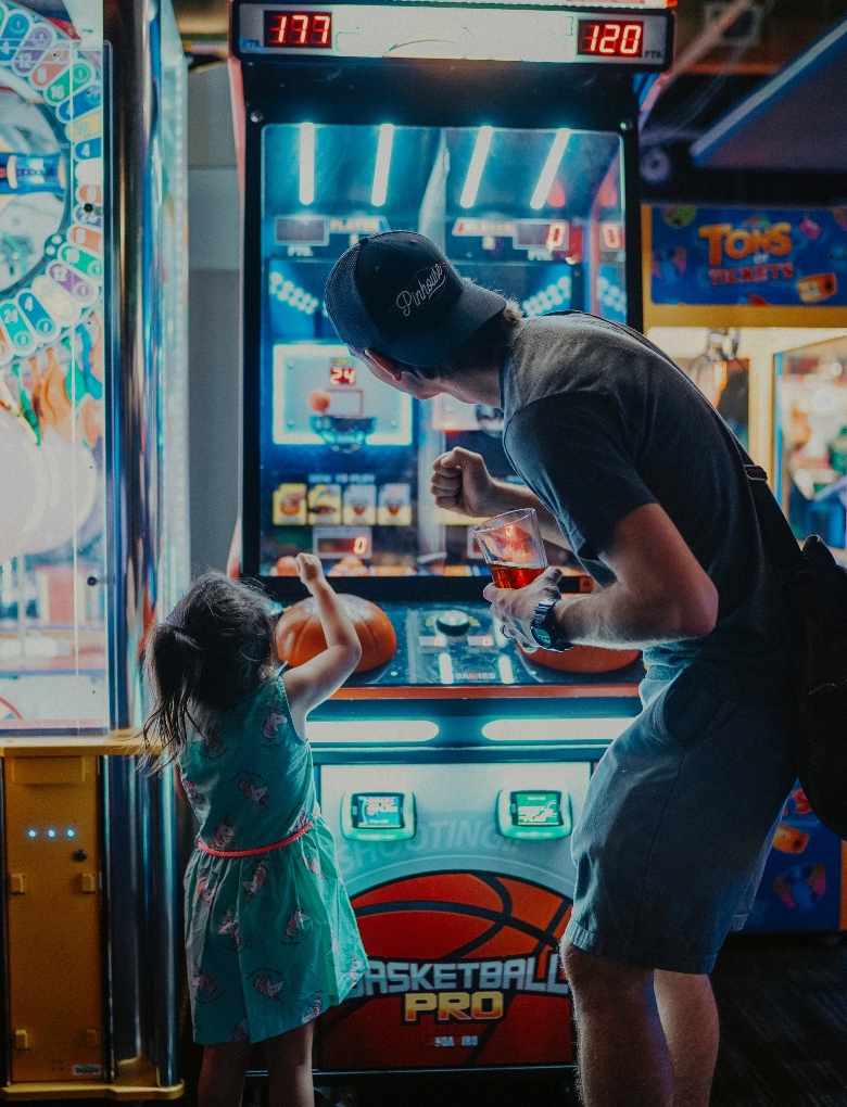 kid playing an arcade game
