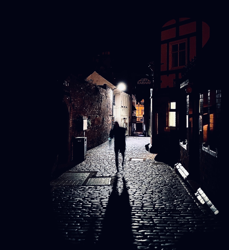 creepy street with a ghost-like figure