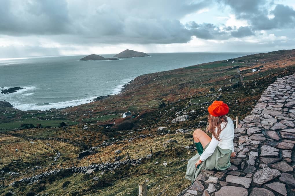woman sitting on Ireland's coast