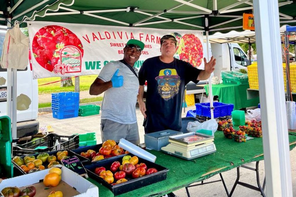 two stand workers at the Torrance Farmers Market