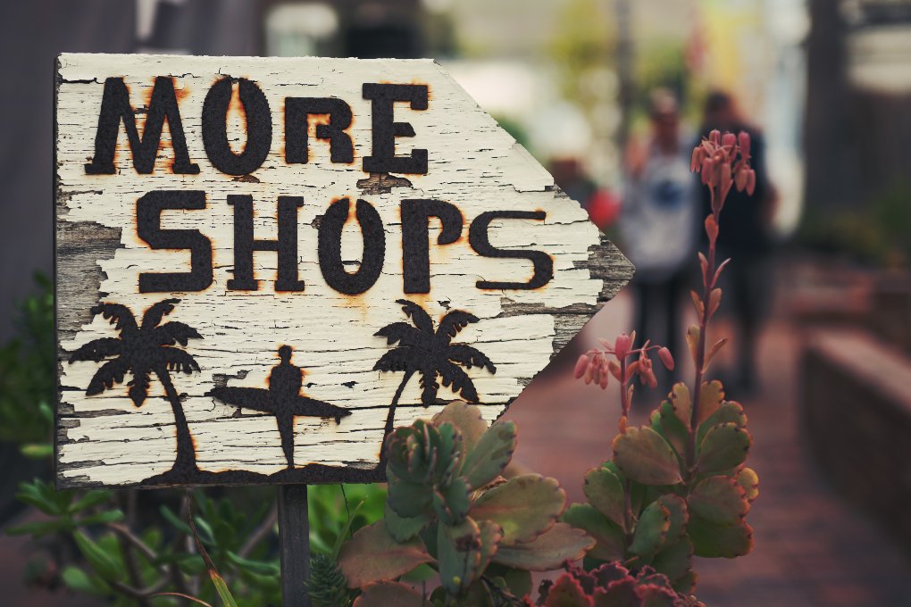 "more shops" sign