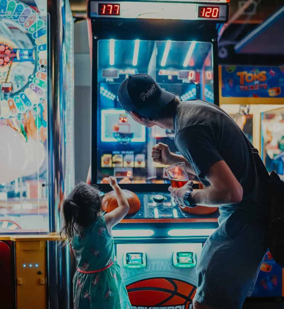 kid and dad playing arcade games