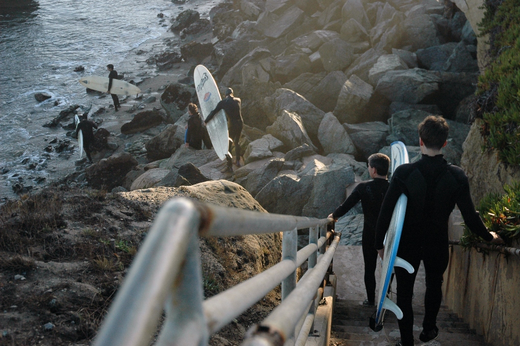 surfers walking down the bluffs in Santa Cruz